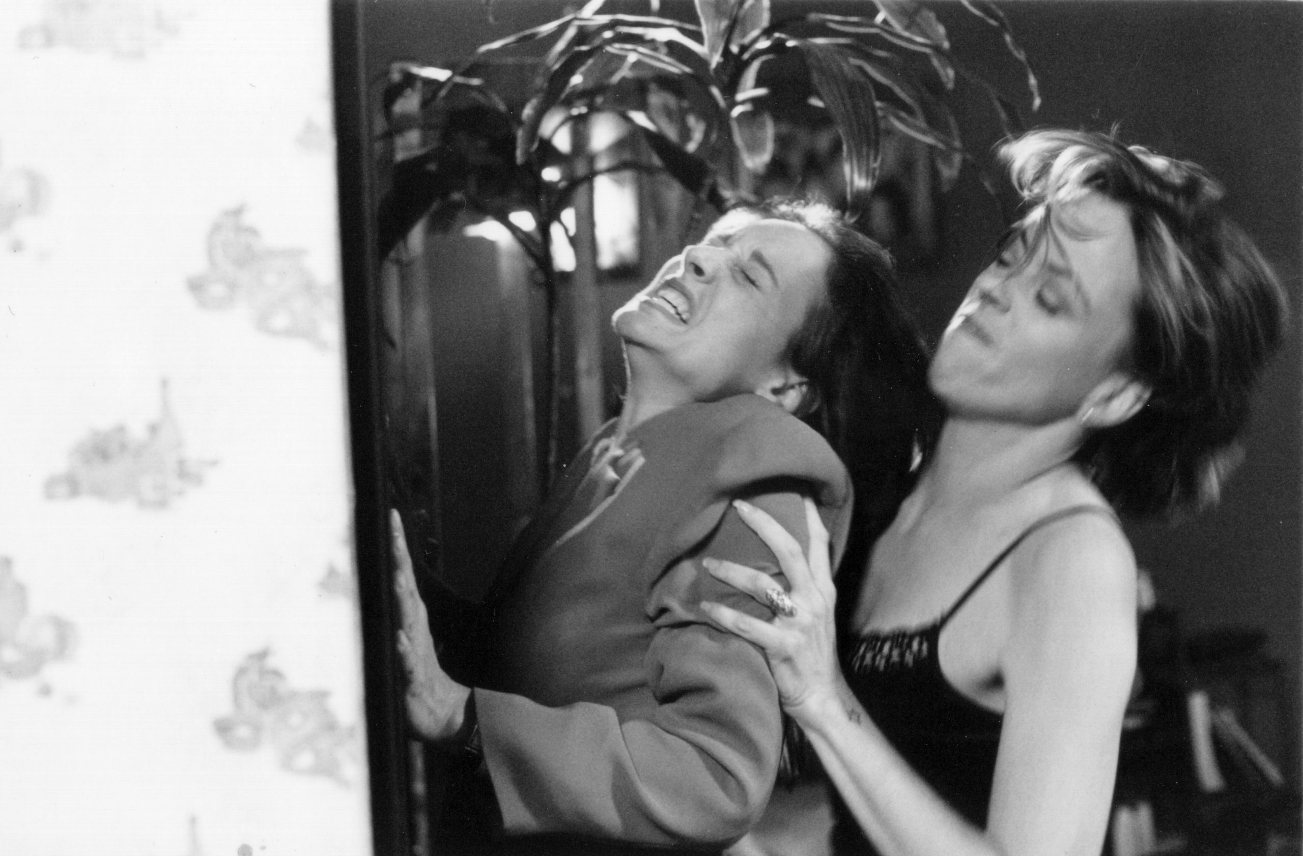 Two actresses grappling in a dressing room, mid-confrontation, black-and-white — When (1999)