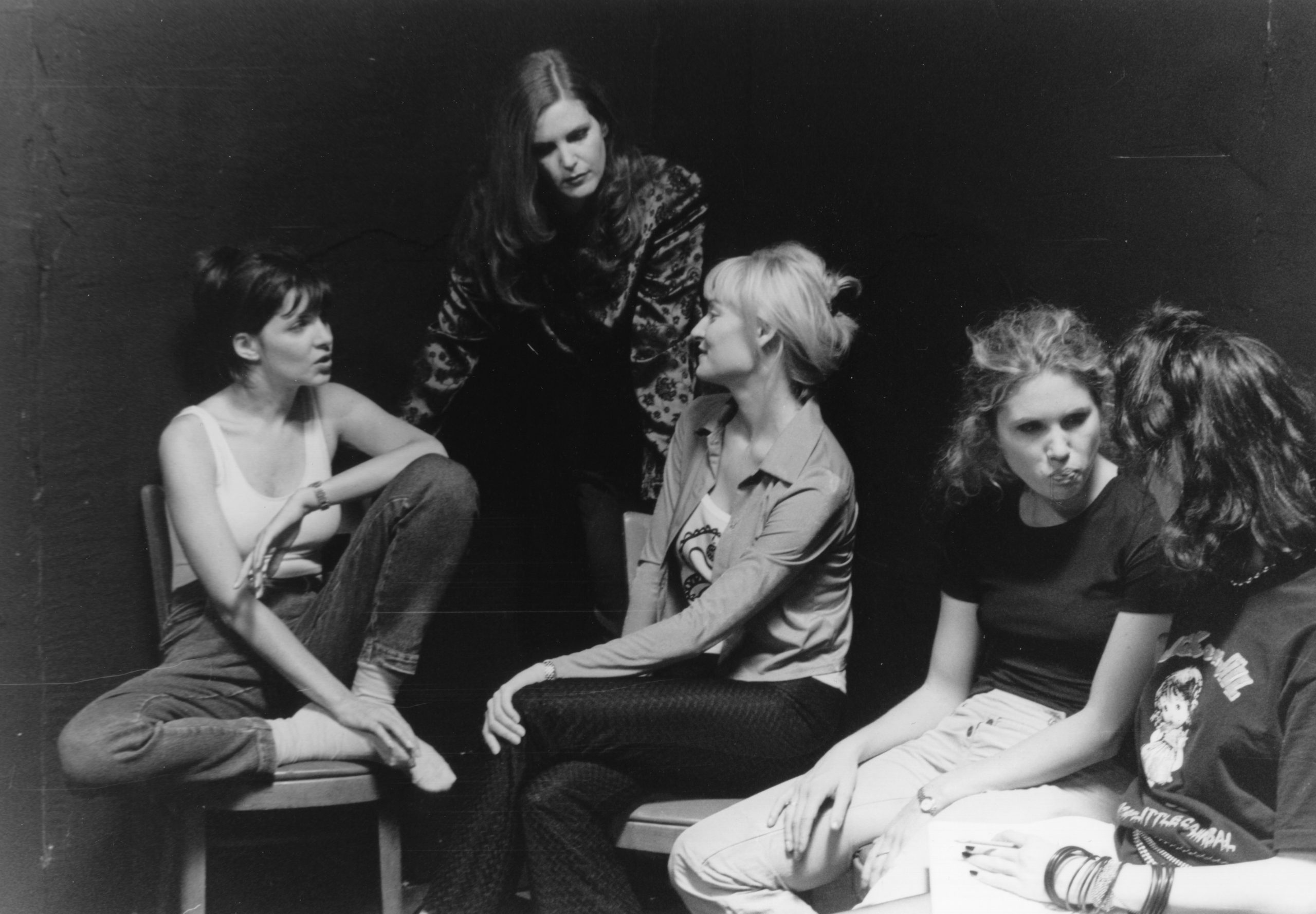 The improvisation class gathered in a circle in a black-box studio, black-and-white — When (1999)